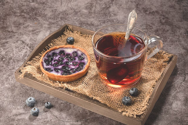 In this example, we brighten an image of a delicious blueberry tart with tea. We cover the entire image by clearing the digital data in the text options for the area position, and we make the image brighter by 15% (new brightness value is 115%). (Source: Pexels.)