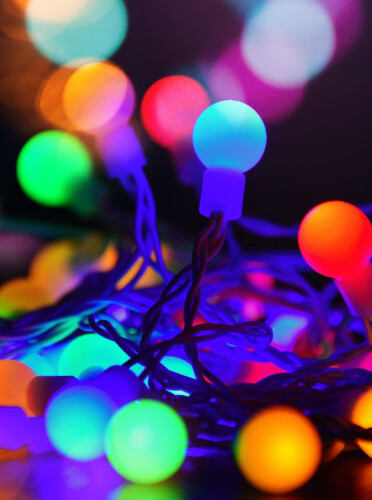 This example visualizes the isolated chroma channel in the Christmas lights image. The chroma channel represents the saturation of each pixel in the image. If a pixel is unsaturated (close to black, white, or gray), it appears on the screen in white. If a pixel is saturated (such as the bright blue or red color of the light bulbs), it appears on the screen in magenta. (Source: Pexels.)