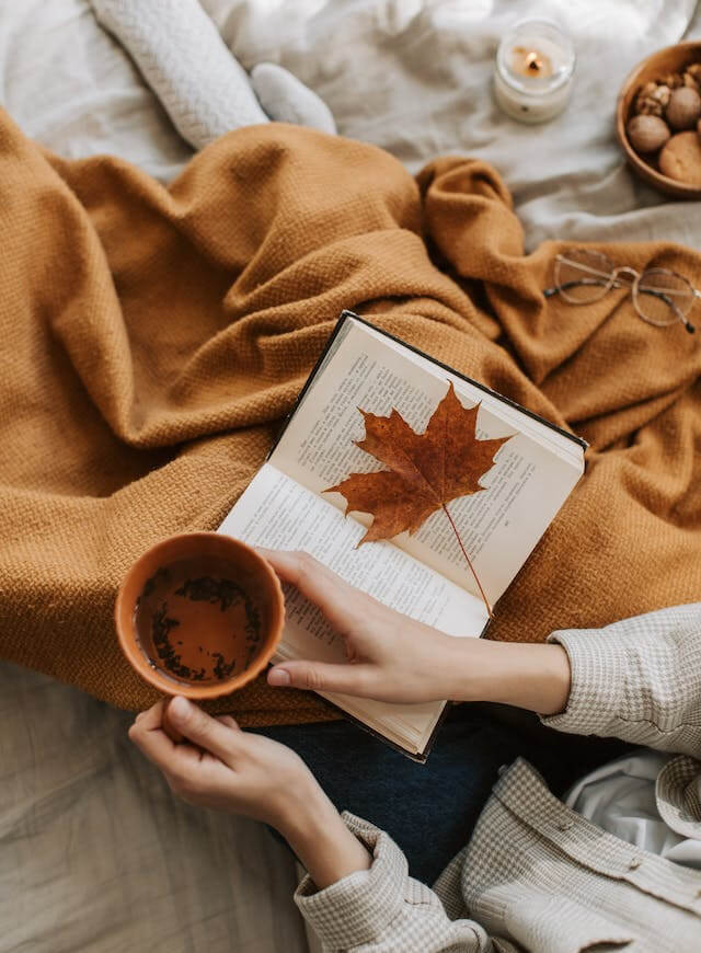 In this example, we create a cozy and comfortable effect using a color fluctuation noise filter. We change 30% of the pixels on the entire image to a slightly lighter or slightly darker shade. As a result, the image of tea and book acquires a delicate graininess effect that creates the atmosphere of coziness. (Source: Pexels.)