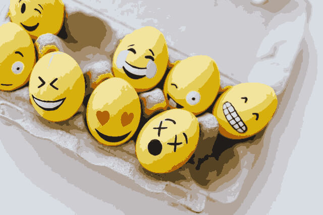 In this example, we apply a cartoonish effect to a cluster of colorful eggs decorated with yellow smiley faces. We achieve this by simplifying the images using only 12 colors, giving the objects a 2D art style. (Source: Pexels.)