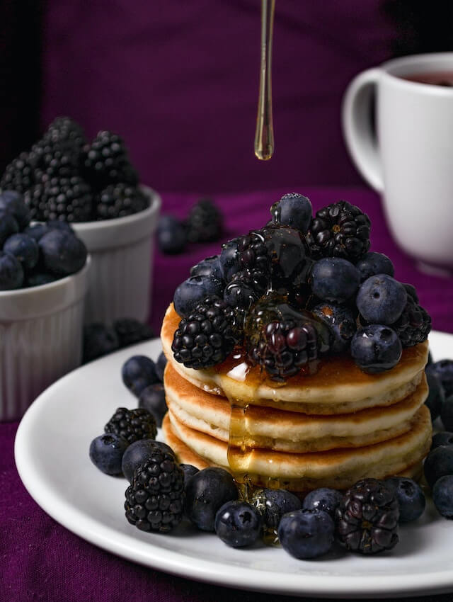 In this example, we split the image of delicious pancakes with berries into three distinct channels of the HSV color space. Because the berries, pancakes, and the background exhibit highly saturated hues, we activate the option to convert the images into grayscale tones for a more neutral view of these vibrant visuals. (Source: Pexels.)