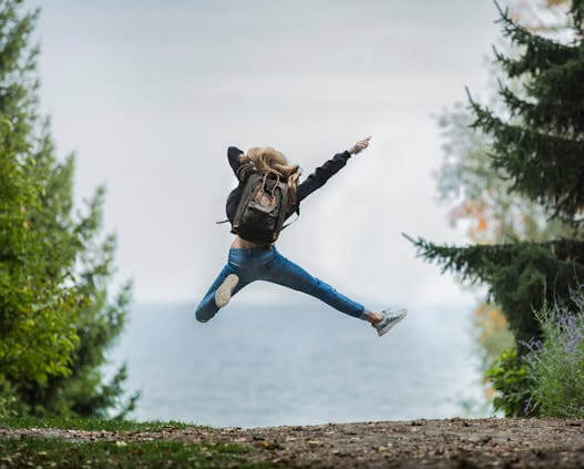 In this example, we capture a dynamic shot of a woman mid-jump and transform it into a vibrant polaroid. We add a clean white border to the image and decorate the polaroid with the playful caption "Gravity negotiable" in bold Comic Sans MS. To enhance the energetic feel, we tilt the polaroid slightly by -5 degrees (a clockwise angle) and add a heavily blurred black shadow with 20% transparency. (Source: Pexels.)