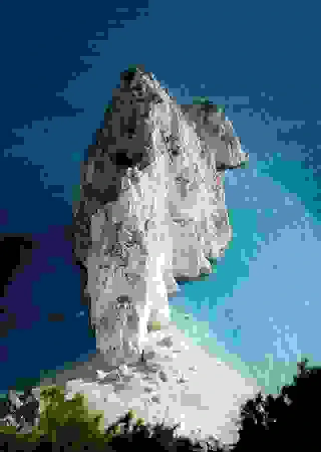 In this example, we add artifacts to the entire WebP image of a rocky cliff on a seashore. To cover the whole WebP, we leave the position and size options of the distortion area empty, which selects the entire WebP. We set the artifact damage level to the maximum "100%", resulting in severe distortions and pixelation characteristics of high-level Zalgo-like compression. (Source: Pexels.)